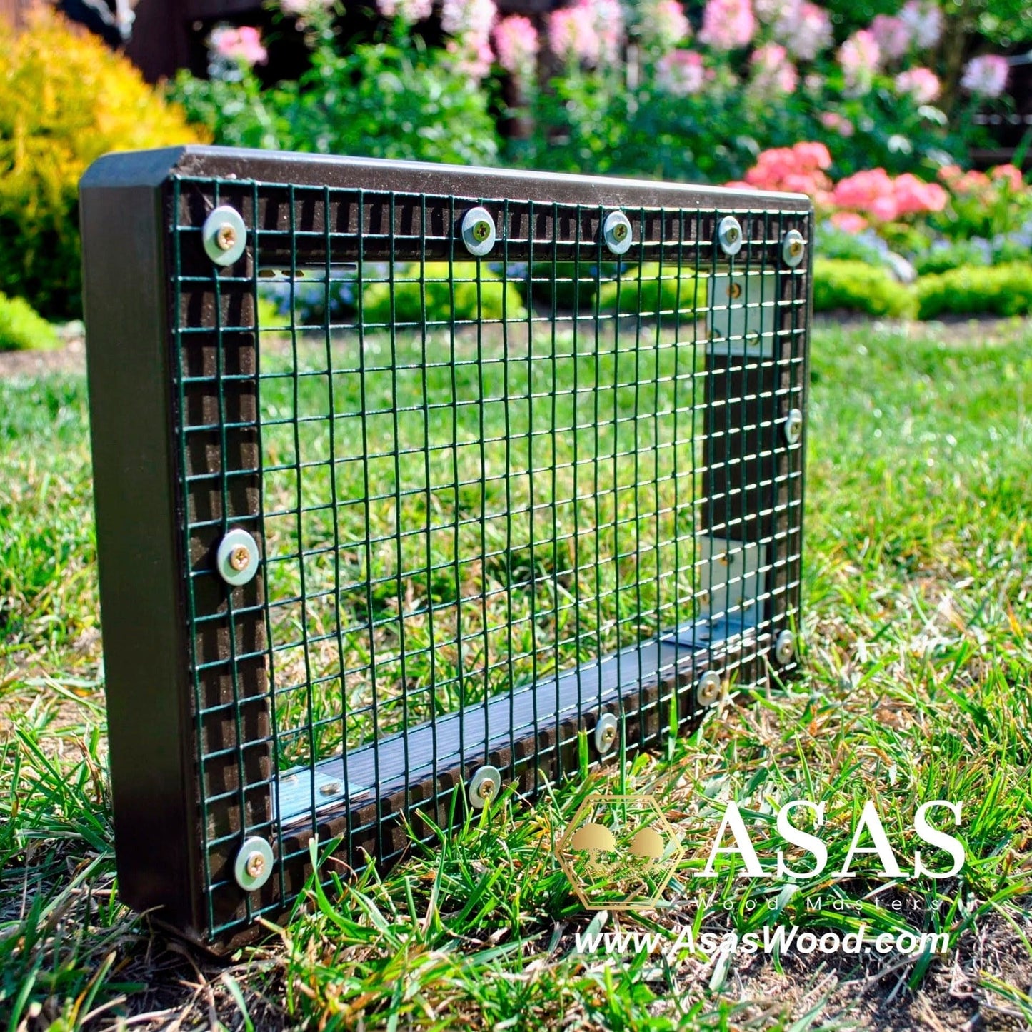 wire mesh grid for bunny litter box, green grass and flowers behind the wire mesh
