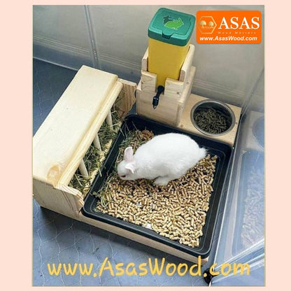 cute white rabbit is eating hay from wooden hay feeder with litter box and nipple no drip water bottle station combo
