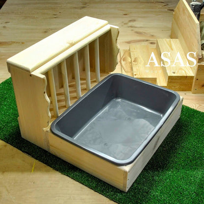 cute rabbit hay feeder with litter box on green cover
