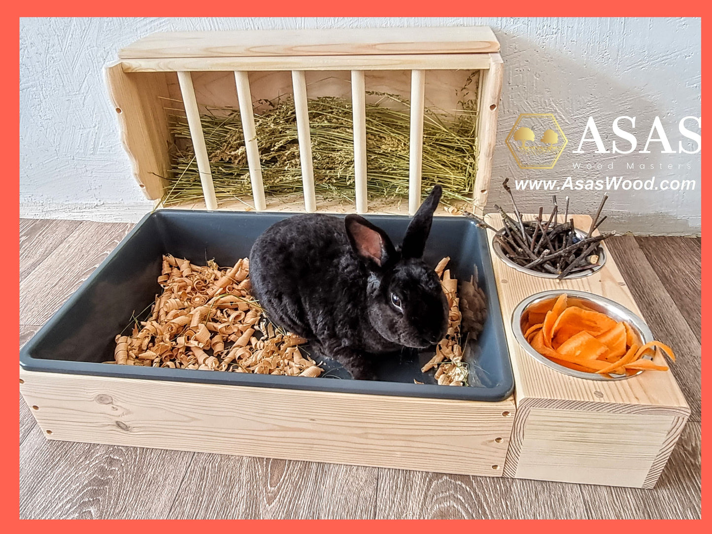 Cute black bunny rabbit in his litter box with hay feeder wooden, made by asaswood